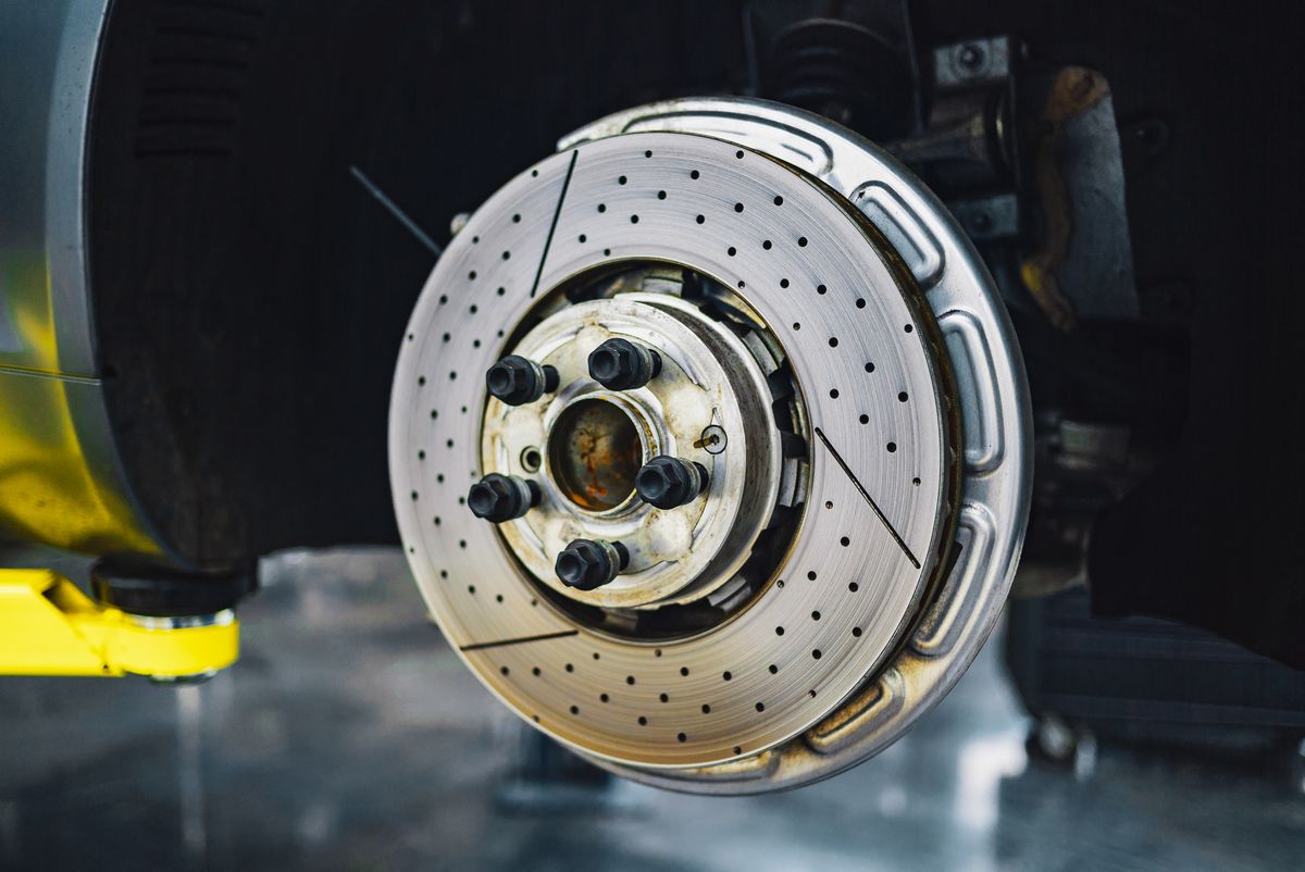 Real close-up photograph of a brake disc in a workshop