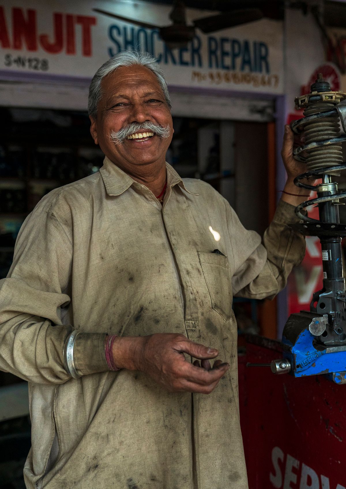 Indian mechanic in an automotive repair workshop
