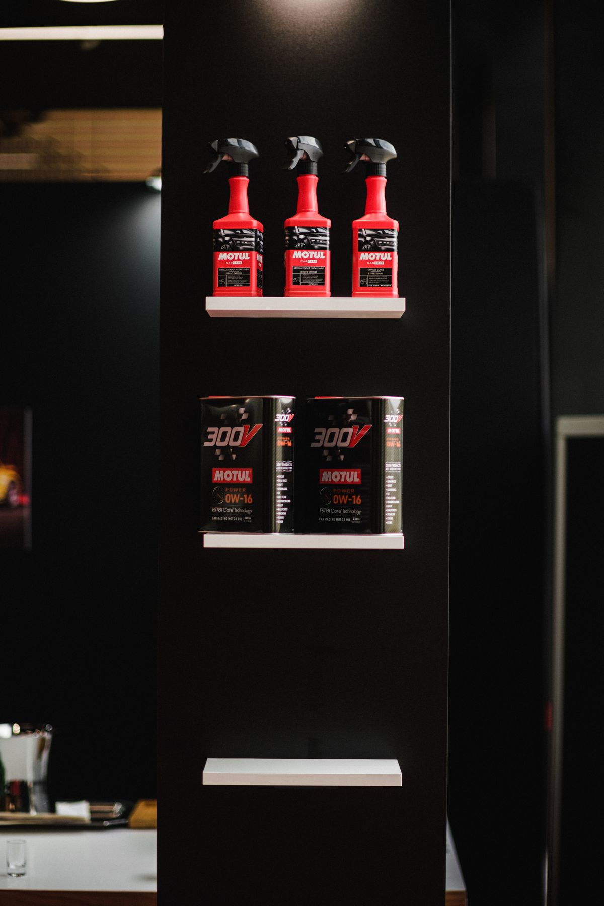 Motor oil and vehicle care products on shop shelves